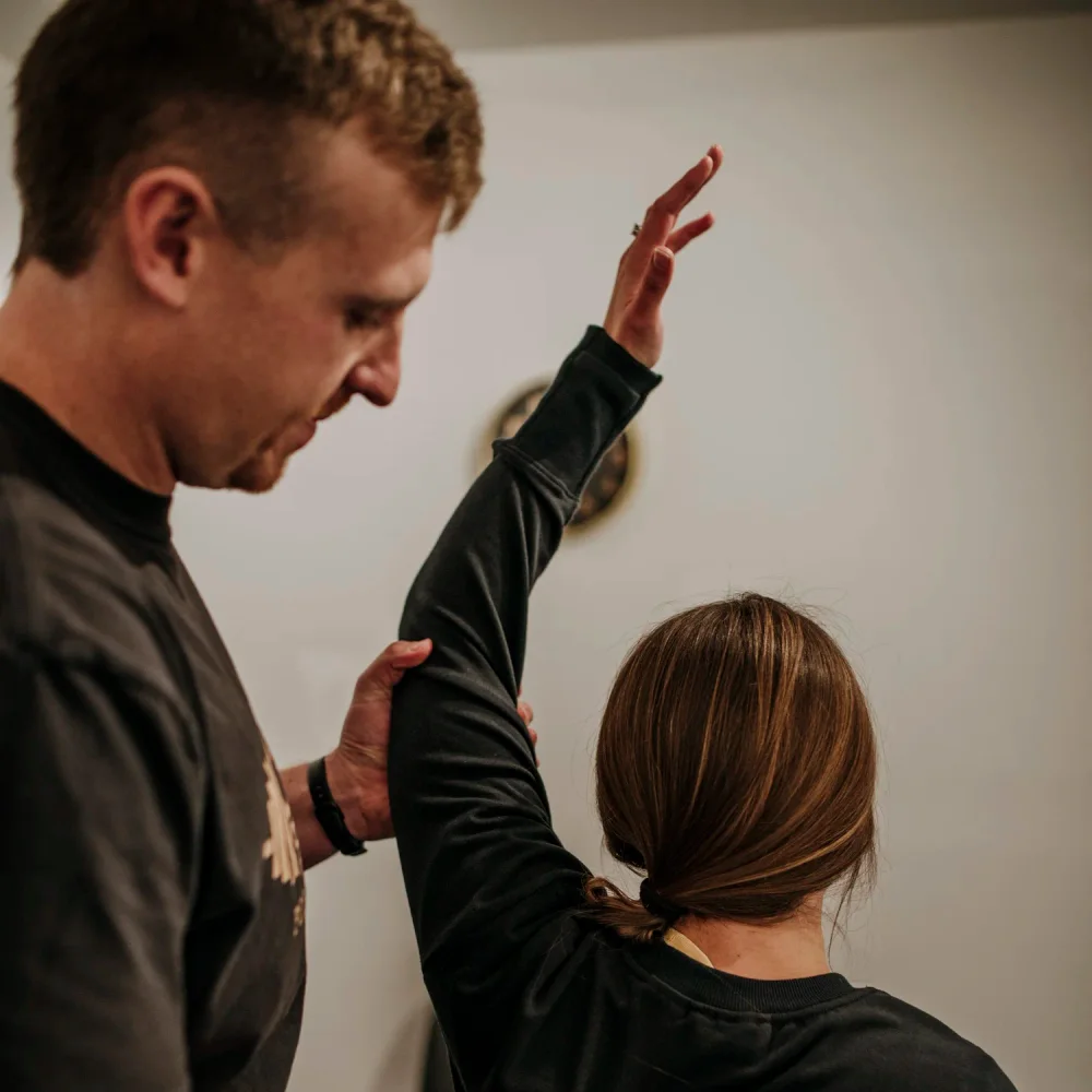 A physical therapist assessing a patient’s shoulder movement