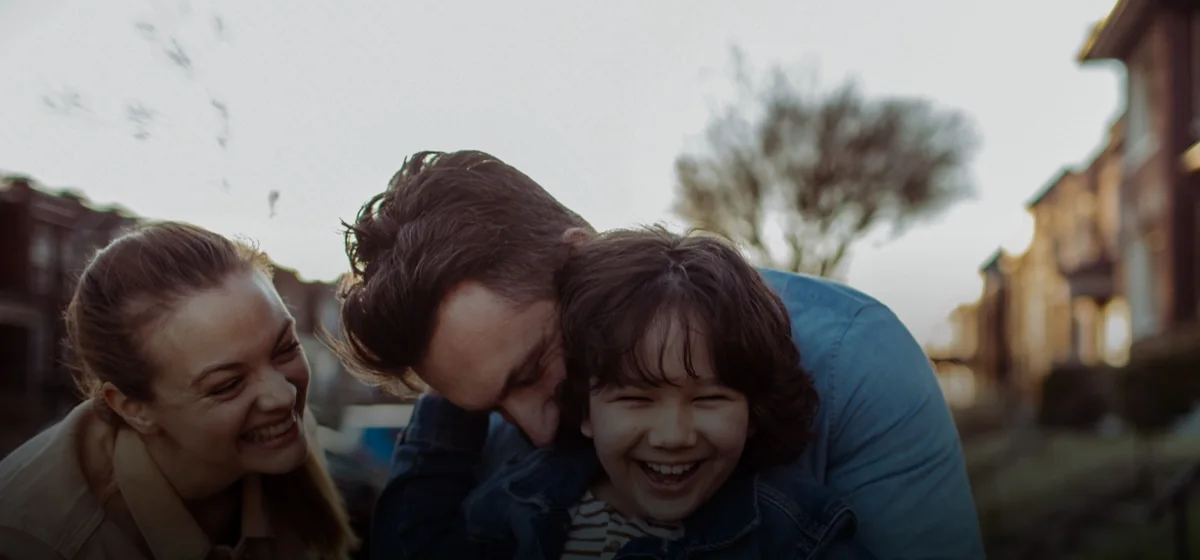 A family laughing together outdoors